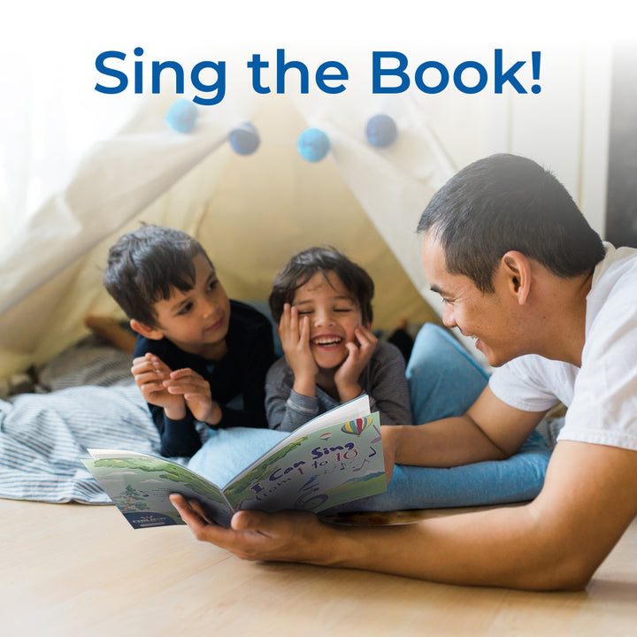 Father reading 'I Can Sing from 1 to 10' book to two children under a tent.